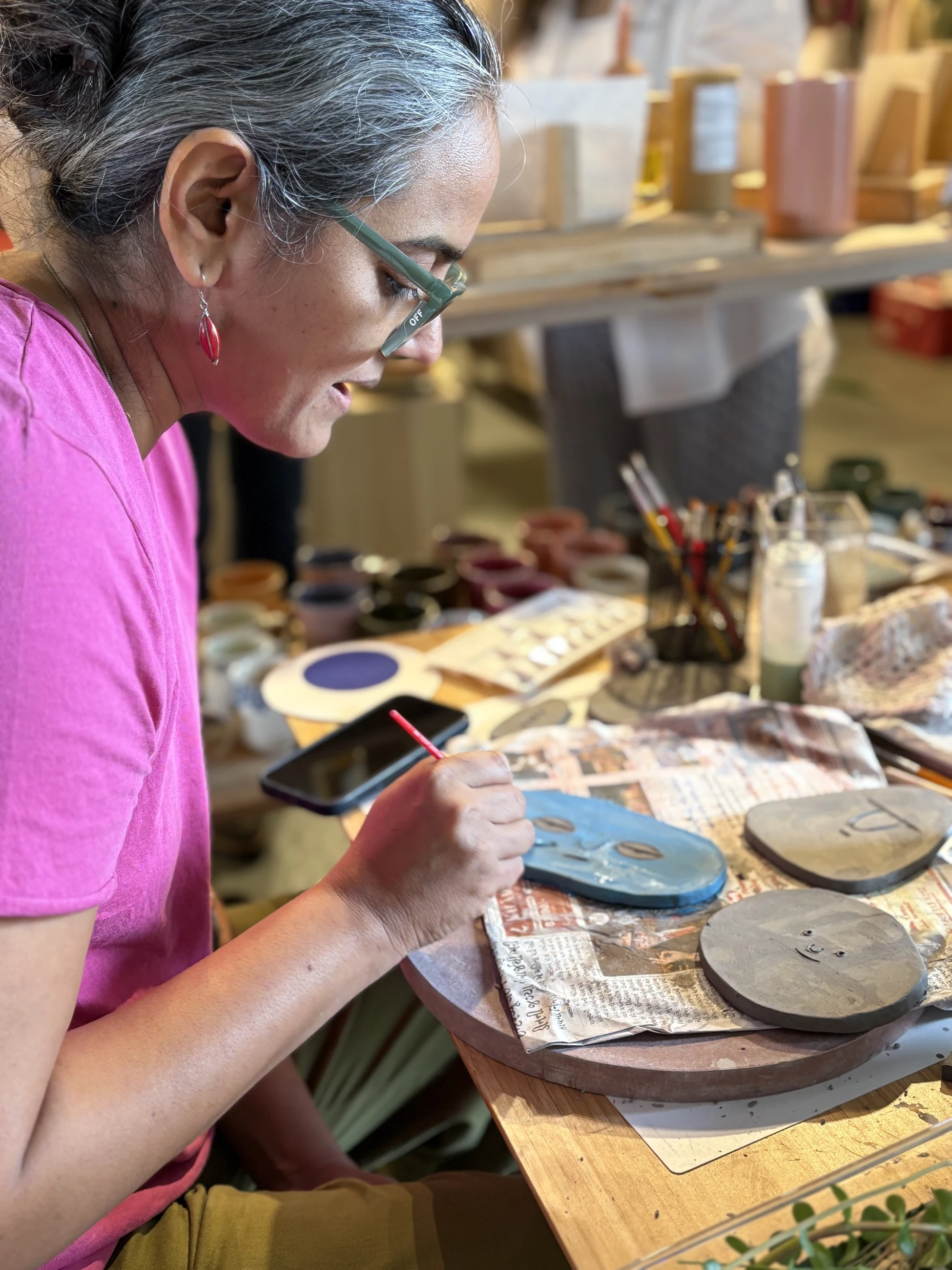 A participant painting at a Mitti workshop